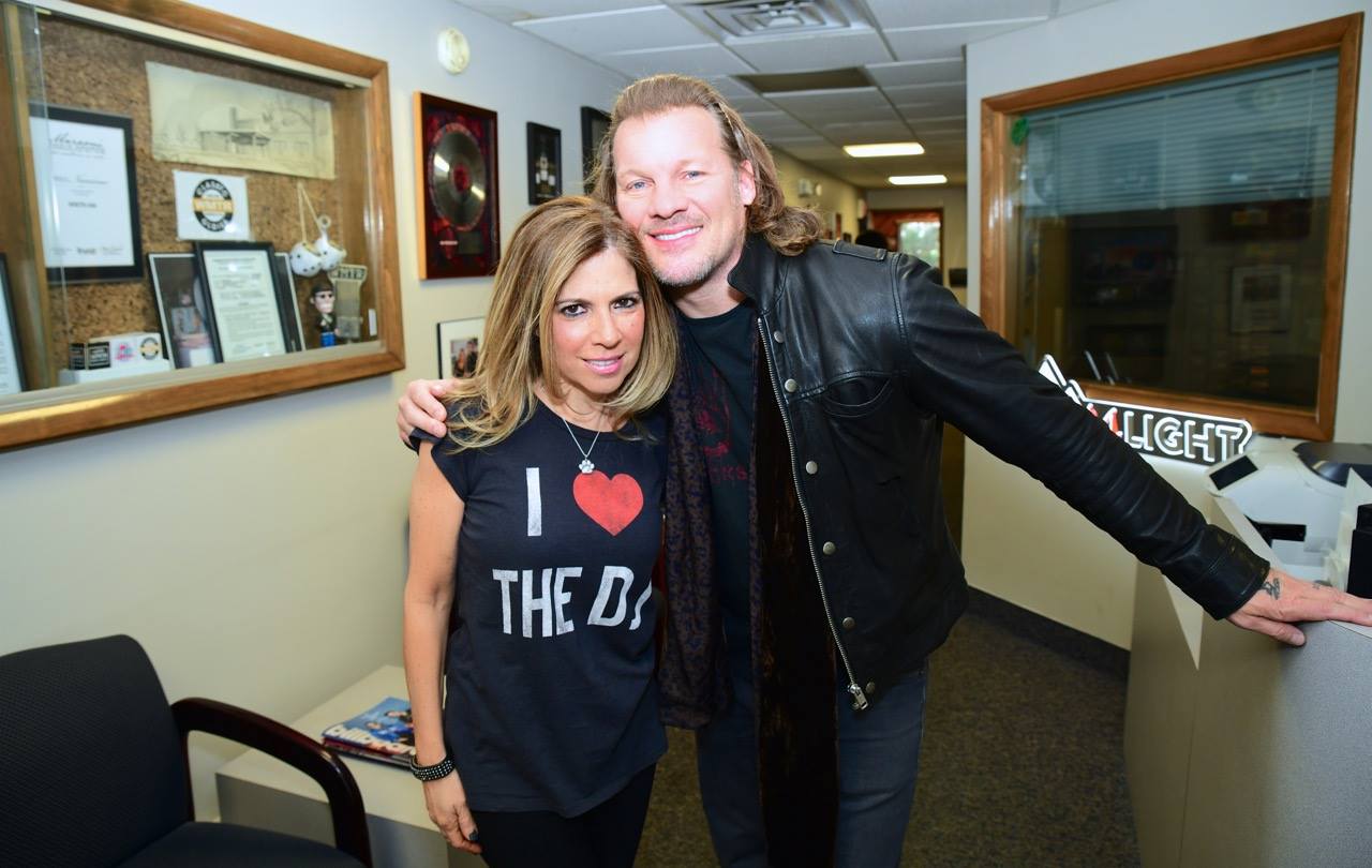 Two people smiling indoors, one wearing an "I ♥ THE DOC" shirt.