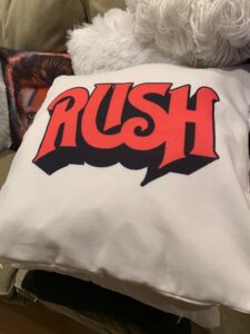 Cushion with "RUSH" logo in red.