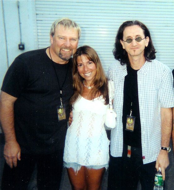 Three people smiling, wearing casual clothes.