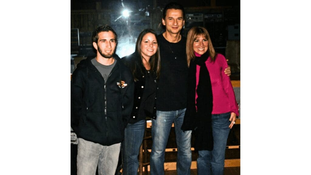 Four people smiling in a group photo.