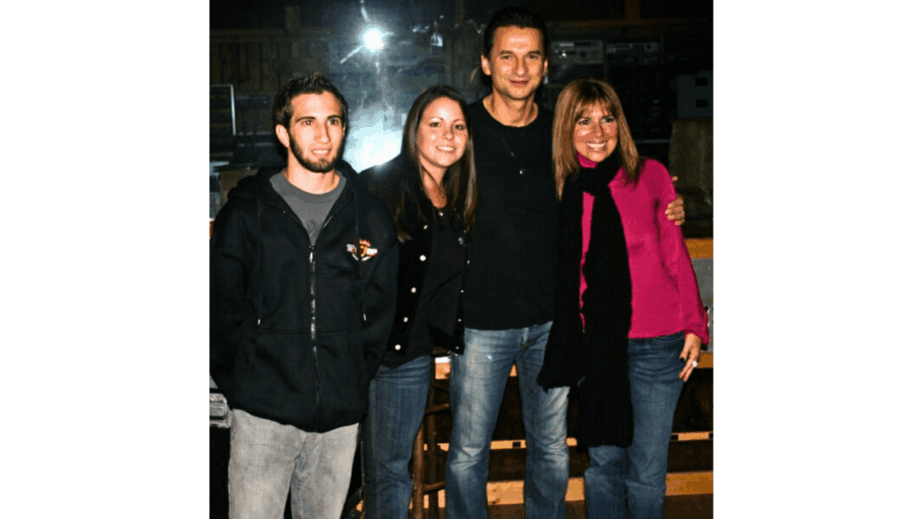 Four people smiling in a group photo.