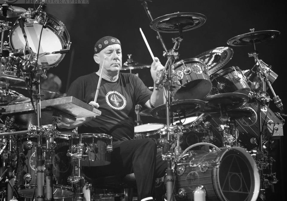 Drummer playing on an elaborate drum set.