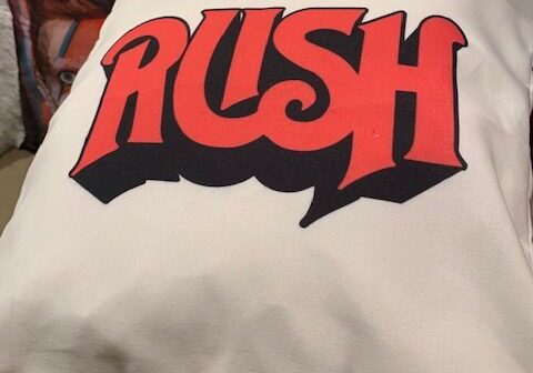 Cushion with "RUSH" logo in red.