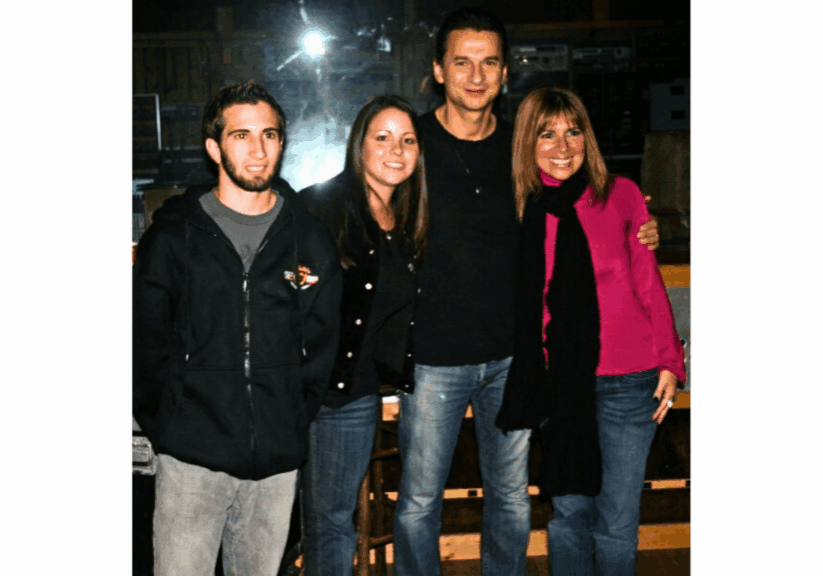 Four people smiling in a group photo.