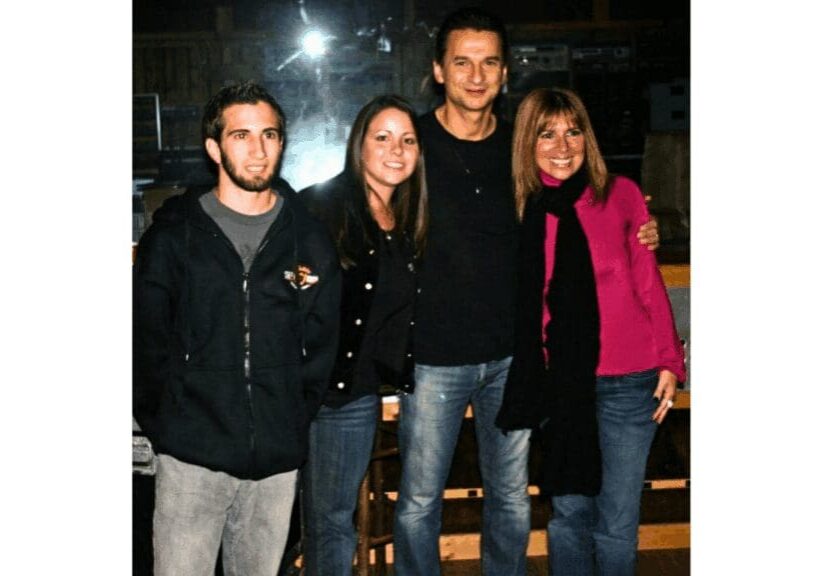 Four people smiling in a group photo.