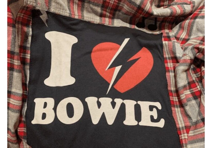 I Love Bowie" shirt on plaid fabric.